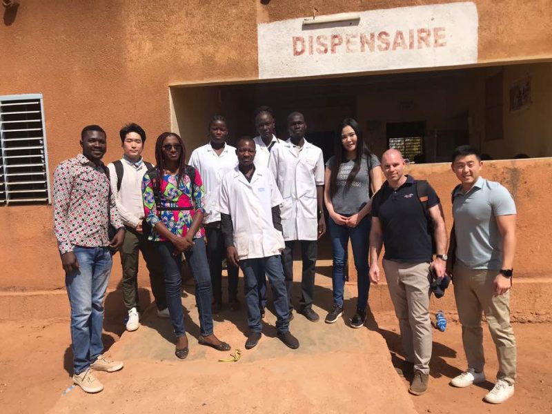 Group photo standing outside a pharmacy in Burkina Faso